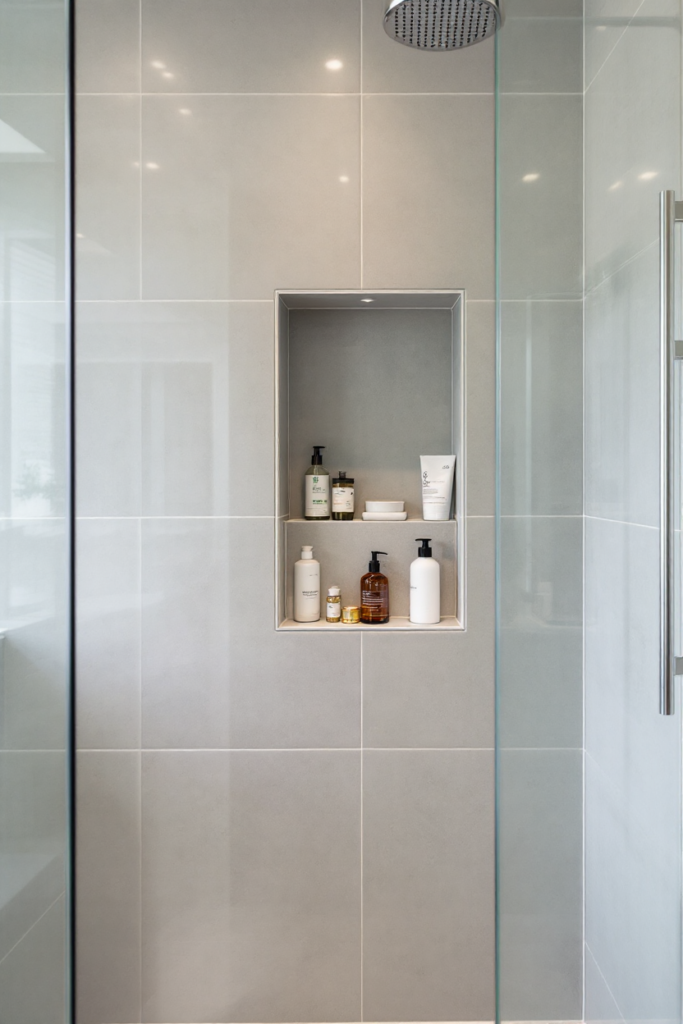 10 Brilliant Small Bathroom Decor Ideas for a Stylish & Spacious Look 10 Small bathroom decor with a sleek glass shower, built-in niche storage, modern gray tiles, and an overhead rainfall showerhead.