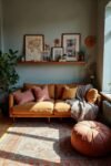 Warm-toned sofa with gallery shelf, plants, and earthy hues reflects boho living room decor ideas