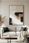 Wall Art for Beige Living Room: Proven Ways to Wow Bold abstract painting in black, white, and tan above beige couch, modern wall art for beige living room.
