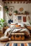 Cozy bedroom with woven headboard, layered textiles, hanging plants, and rustic trunk as boho bedroom furniture