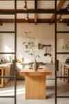 Modern Japandi Industrial Kitchen Ideas: Blending Minimalism & Urban Edge Minimalist Japanese Kitchen with a light wood island, ceramic vase, and visible ceiling beams.