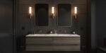 Modern double vanity with wood cabinetry, matte black tile walls, warm brass fixtures, and vertical light sconces, embodying a sleek Black Bathroom Ideas aesthetic.