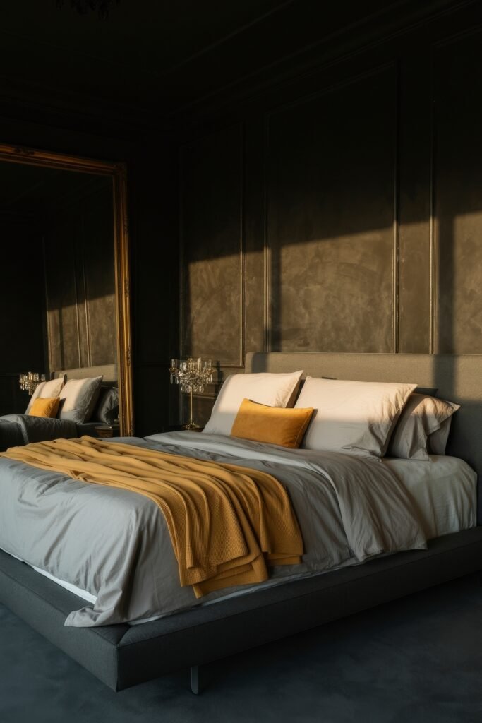 Masculine Luxury Bedroom: Genius Luxe Ideas 2 Refined bedroom in soft golden-hour lighting, with dark paneled walls, a full-height mirror, and a bed layered in white, gray, and mustard bedding, accented with a plush amber throw.