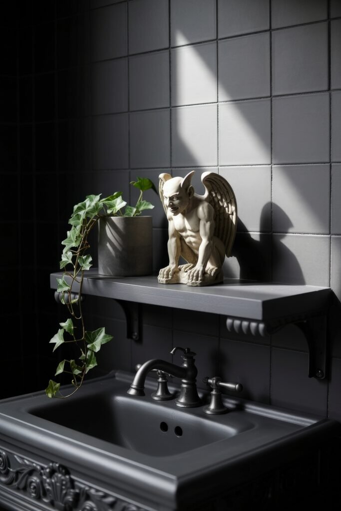Gothic Bathroom Ideas: Genius Touches for Moody Glam 32 Matte black sink beneath a gray tiled wall, decorated with a creeping ivy plant and a small gargoyle statue perched on a floating shelf, capturing a moody Gothic Bathroom Ideas scene.