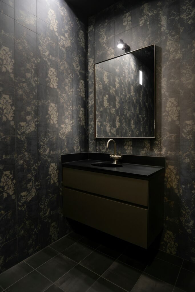 Gothic Bathroom Ideas: Genius Touches for Moody Glam 15 Contemporary bathroom with a floating black vanity, brushed steel fixtures, and shadowy floral wallpaper tiles, expressing a modern take on Dark & Moody Bathroom Themes.