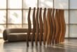 A modern living room featuring a sculptural wooden living room divider with undulating vertical slats, placed in front of a minimalist cream boucle sofa and large grid window filtering soft daylight.