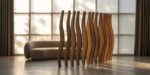A modern living room featuring a sculptural wooden living room divider with undulating vertical slats, placed in front of a minimalist cream boucle sofa and large grid window filtering soft daylight.