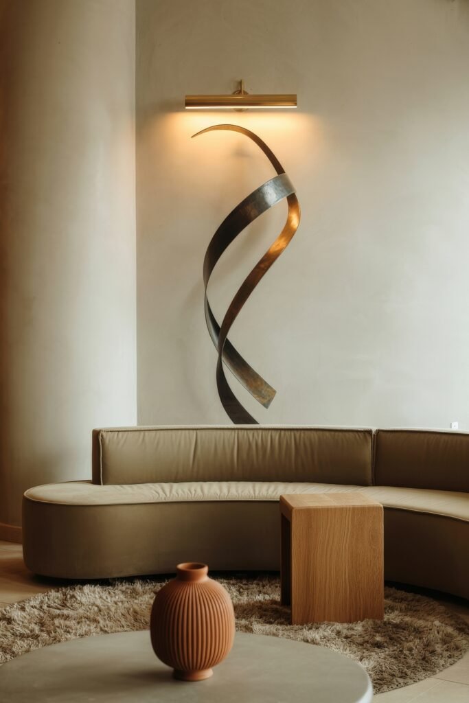 Modern Luxury Living Room: Designing a Sleek Luxe Lounge 14 Modern luxury living room featuring a cream curved sofa, oversized textured wall relief, circular marble coffee table and brass bowl on a pale fur rug
