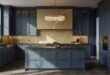 Spacious modern kitchen featuring matte blue kitchen cabinets, a dark island countertop, and a striking gold-veined marble backsplash under a crystal chandelier.