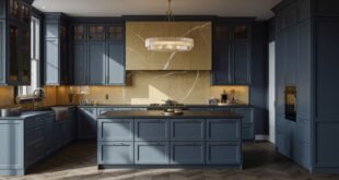 Spacious modern kitchen featuring matte blue kitchen cabinets, a dark island countertop, and a striking gold-veined marble backsplash under a crystal chandelier.