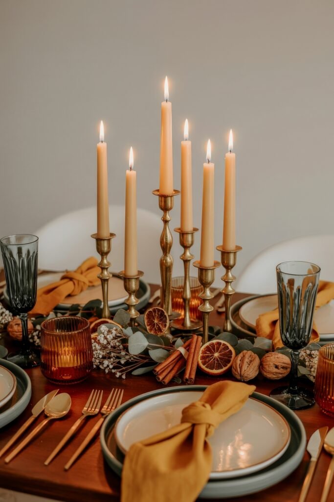 Effortless Harvest Table Looks: Thanksgiving Tablescapes Simple & Chic 18 Sophisticated thanksgiving tablescapes simple design with gold candlesticks, amber and black goblets, mustard napkins, and a natural garland of dried citrus slices, cinnamon sticks, and eucalyptus.