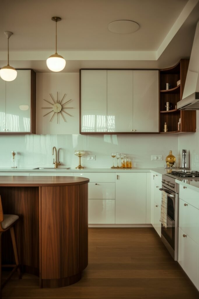 Inspiring Styles to Refresh Your White Kitchen Cabinets 19 Mid-century modern kitchen with glossy white cabinets, walnut wood accents, minimalist lighting, and brass details including a sleek faucet and wall clock.