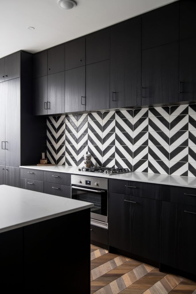 Stunning Ways to Style Black Kitchen Cabinets 27 Bold monochrome kitchen with black kitchen cabinets and chevron-patterned black-and-white tile backsplash, paired with white countertops and wooden herringbone flooring.