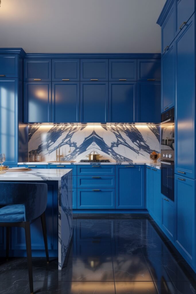 Inspiring Looks for Blue Kitchen Cabinets in Every Style 32 Elegant kitchen featuring glossy blue kitchen cabinets, a dramatic blue-and-white marble backsplash, and a matching marble-topped island with modern lighting.
