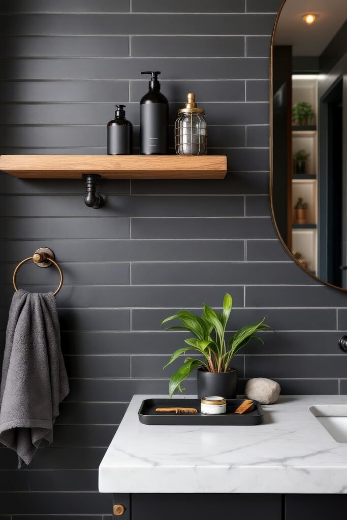 Gorgeous Ways to Elevate Your Bathroom Shelf Decor 32 Modern masculine bathroom with matte black subway tile walls, a light wood floating shelf holding sleek black bottles and a vintage jar, and a marble counter decorated with a green potted plant, comb, and grooming essentials.