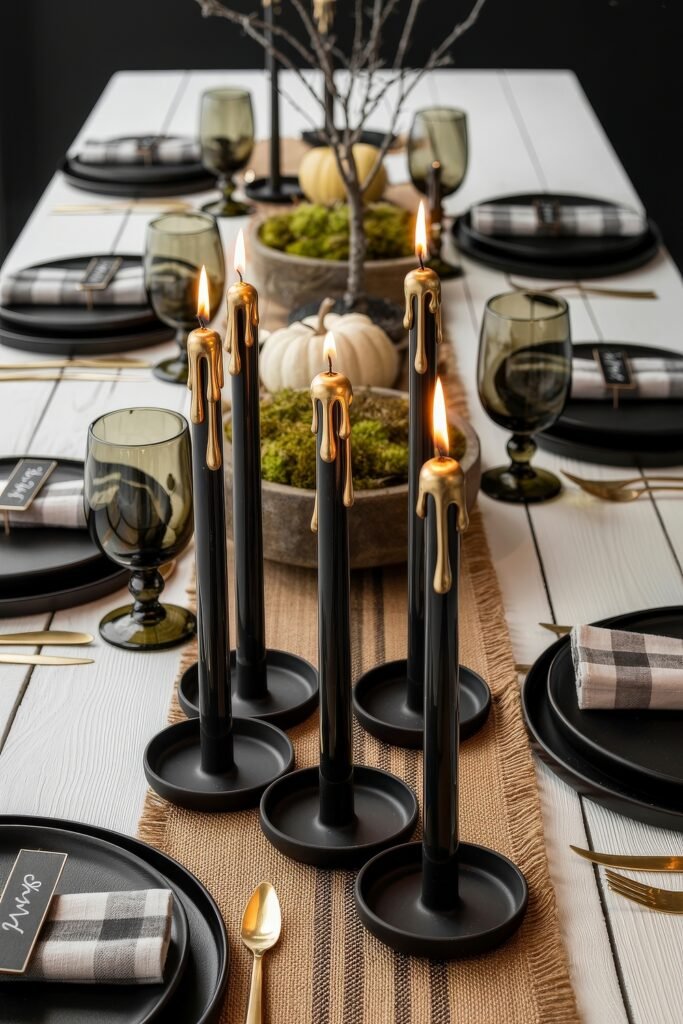 Monochrome Marvels: Black & White Thanksgiving Tablescapes 32 Moody black and white thanksgiving tablescape with dramatic black candles dripping gold wax, smoky goblets, plaid napkins with name tags, gold flatware, and white pumpkins in moss centerpieces.