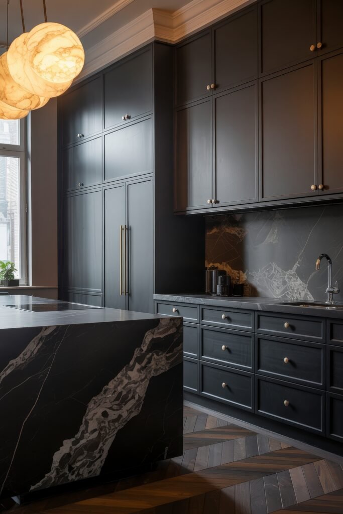 Stunning Ways to Style Black Kitchen Cabinets 19 Sophisticated kitchen design with floor-to-ceiling matte black cabinetry, dark marble countertops and backsplash, brass accents, and a dramatic marble island paired with sculptural pendant lighting.
