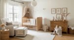 Dreamy & Stylish Baby Nursery Ideas for Girl Cozy neutral nursery with a wooden crib under a canopy, a cushioned armchair, dresser with decor, and soft plush toys, creating a warm dreamy nursery bedroom.