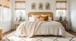Dreamy Ways to Style a Cozy Boho Bedroom Bright bedroom with a rattan headboard, soft neutral bedding, warm-toned pillows, and matching wooden nightstands beneath windows with bamboo shades, styled with green ceramic lamps and minimalist botanical wall art, creating a cozy boho bedroom vibe.