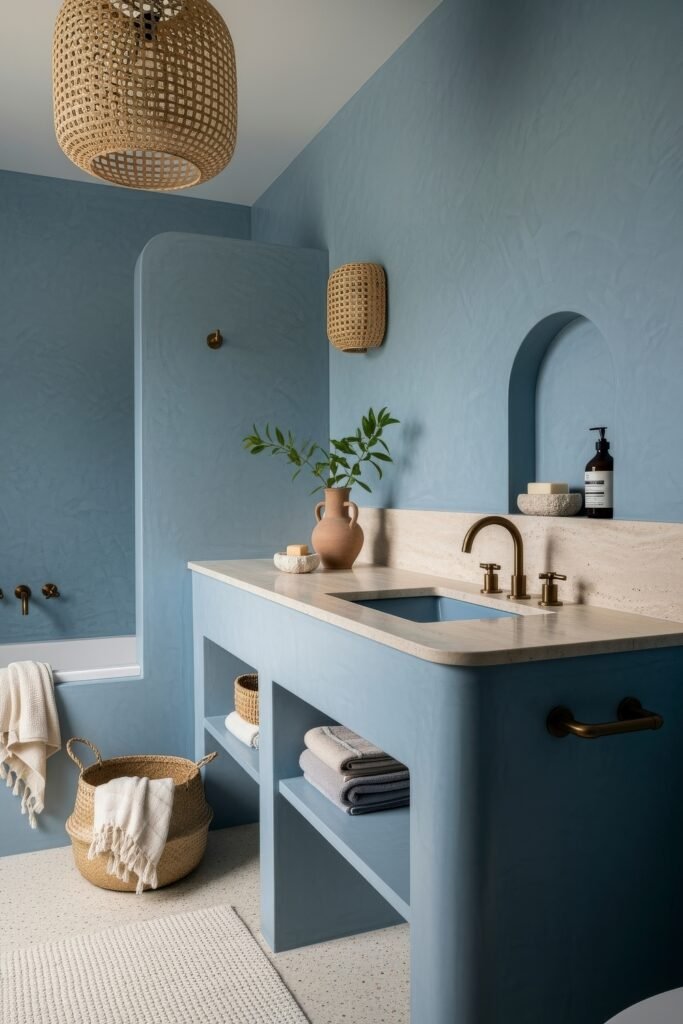 Blue Bathroom Decor: Fresh, Wow-Worthy Ideas 21 Serene bathroom with soft blue walls, stone countertop, and woven baskets blending natural textures into blue bathroom decor.