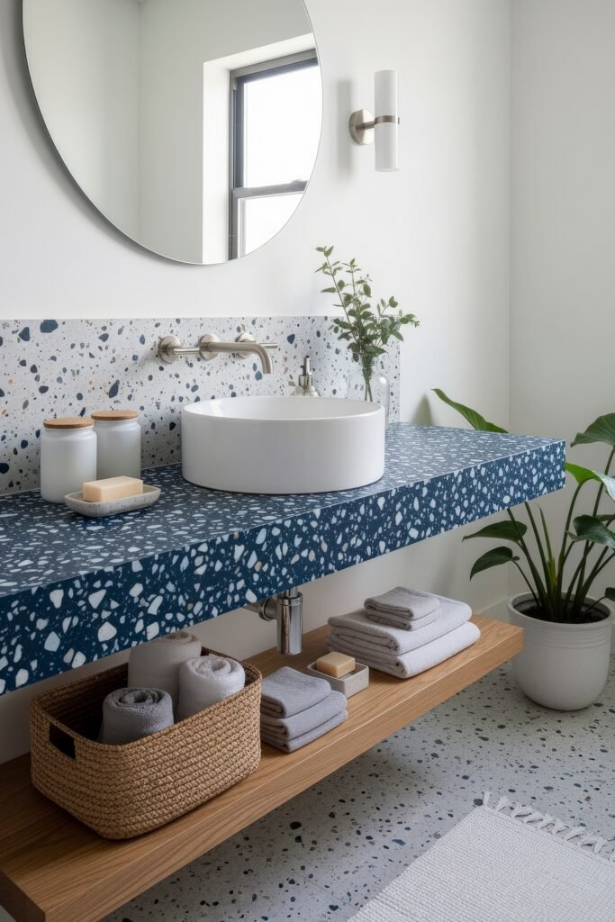 Blue Bathroom Decor: Fresh, Wow-Worthy Ideas 9 Minimalist bathroom with terrazzo counters, circular mirror, and touches of greenery highlighting fresh blue bathroom decor.