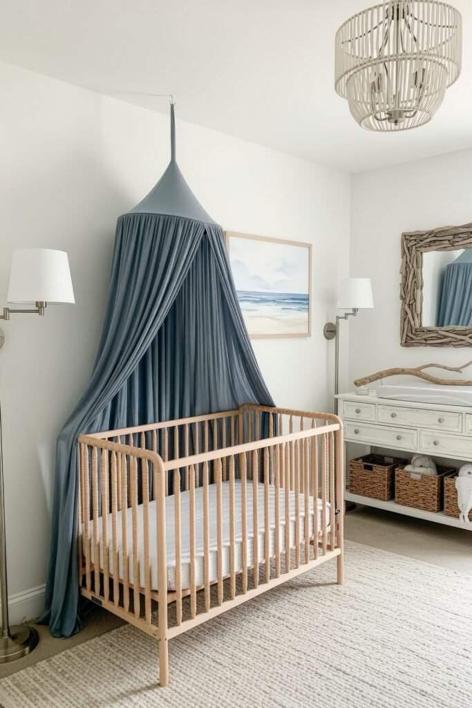 Dreamy Nursery Bedrooms: Baby Nursery Ideas for Boy 11 Coastal-inspired nursery with a light wood crib under a navy canopy, driftwood mirror, and wicker baskets adding natural texture.