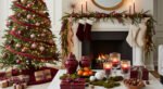 Living room with a glowing fireplace, burgundy Christmas tree decorations, and stockings hung on a garlanded mantel for a Cozy Christmas Décor scene.