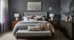 Grey bedroom ideas for a calm, stylish retreat Elegant grey bedroom with a tufted headboard, layered bedding in grey and blush tones, wooden side tables, and modern decor accents.
