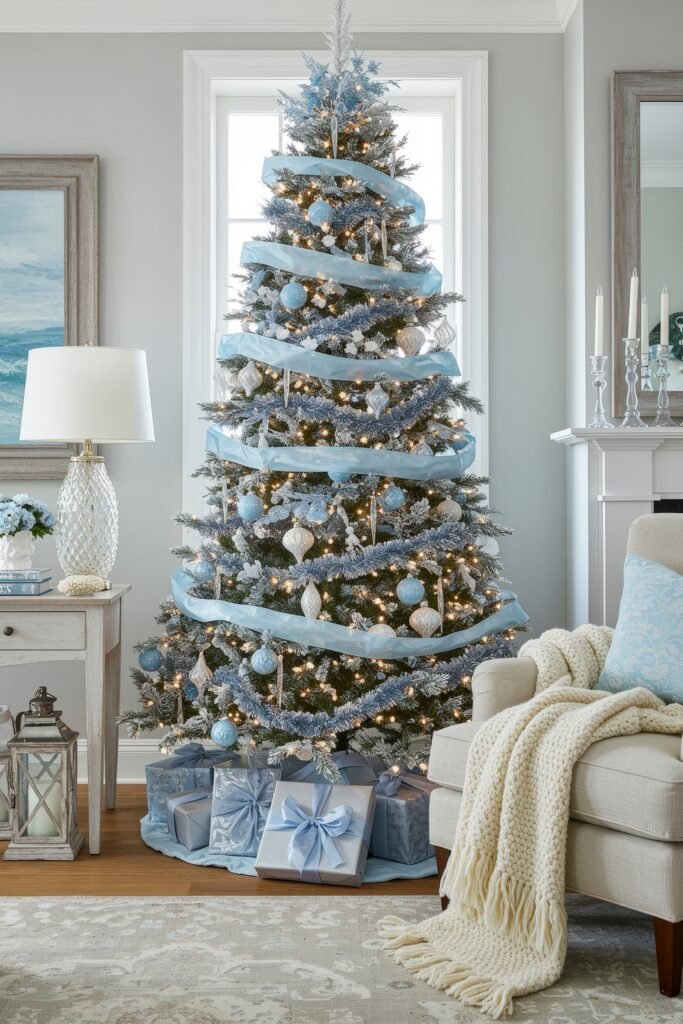 Cozy, Collected Magic With Vintage Christmas Decor Ideas 23 Living room with a frosty blue-and-white Christmas tree wrapped in light blue ribbon, decorated with icy ornaments and surrounded by pastel blue presents for cozy Christmas décor.