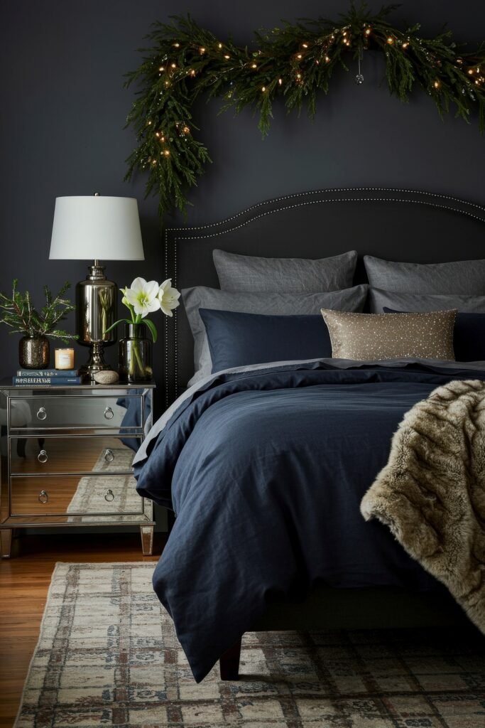 Elevate Your Bedroom with Cozy Christmas Bedding 4 Dark-toned bedroom with navy bedding, faux fur throw, and metallic accents, framed by glowing garland above the headboard for elegant holiday décor.