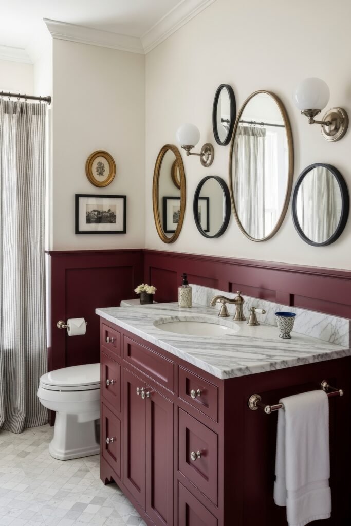 13 Bold Ideas for Red Bathroom Decor That Wow 16 Traditional bathroom with red cabinetry, marble countertop, and a gallery wall of oval and round mirrors creating a refined style.