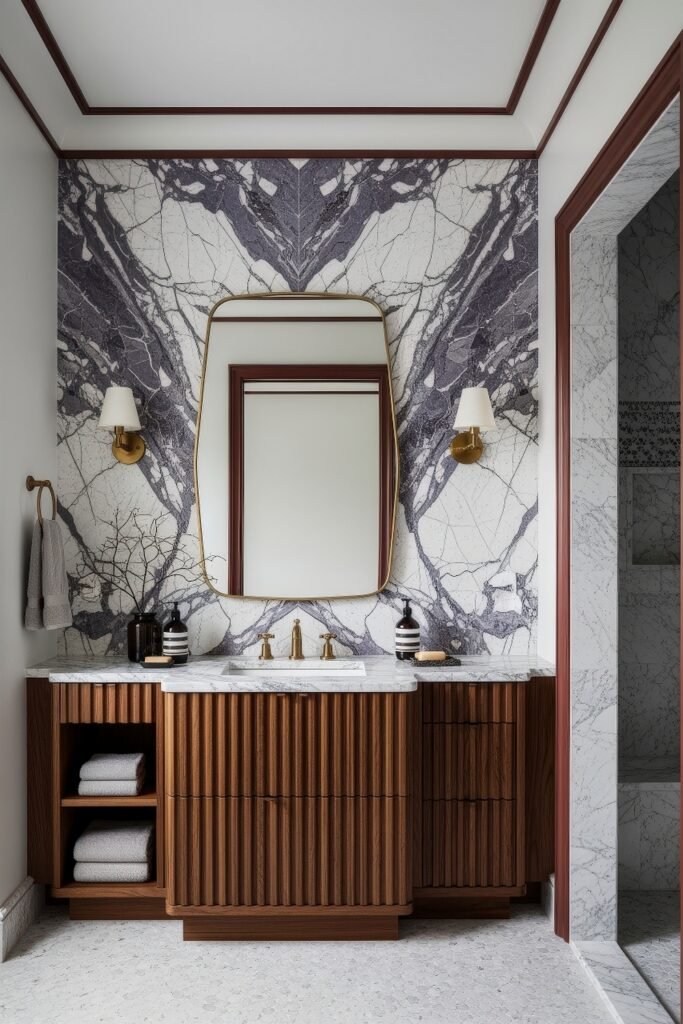 Calacatta Viola Bathroom Ideas for a Richer Look 2 Fluted wood bathroom vanity with marble top and brass fixtures against a bookmatched Calacatta Viola stone wall beside a marble shower