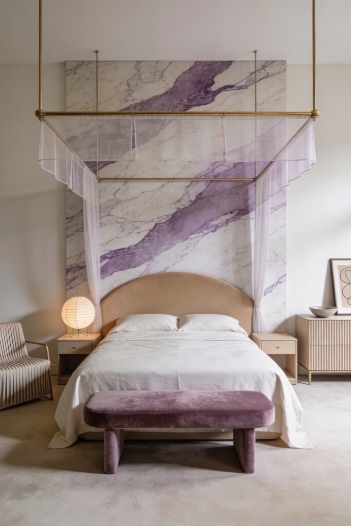 Soft minimalist bedroom with a brass canopy bed sheer drapery and a lavender veined marble headboard wall