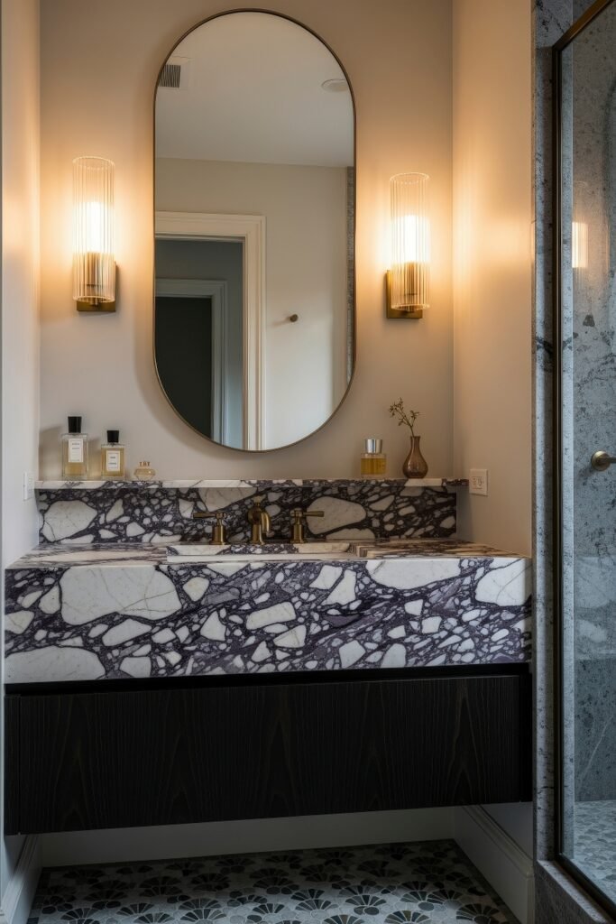 Calacatta Viola Bathroom Ideas for a Richer Look 15 Compact bathroom with Calacatta Viola stone vanity black cabinet doors and oval mirror between glowing sconces beside a glass shower