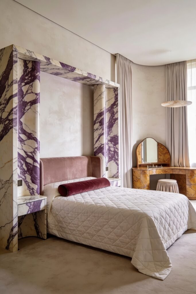 Sculptural bedroom with a pink upholstered bed set within a bold purple veined marble canopy frame